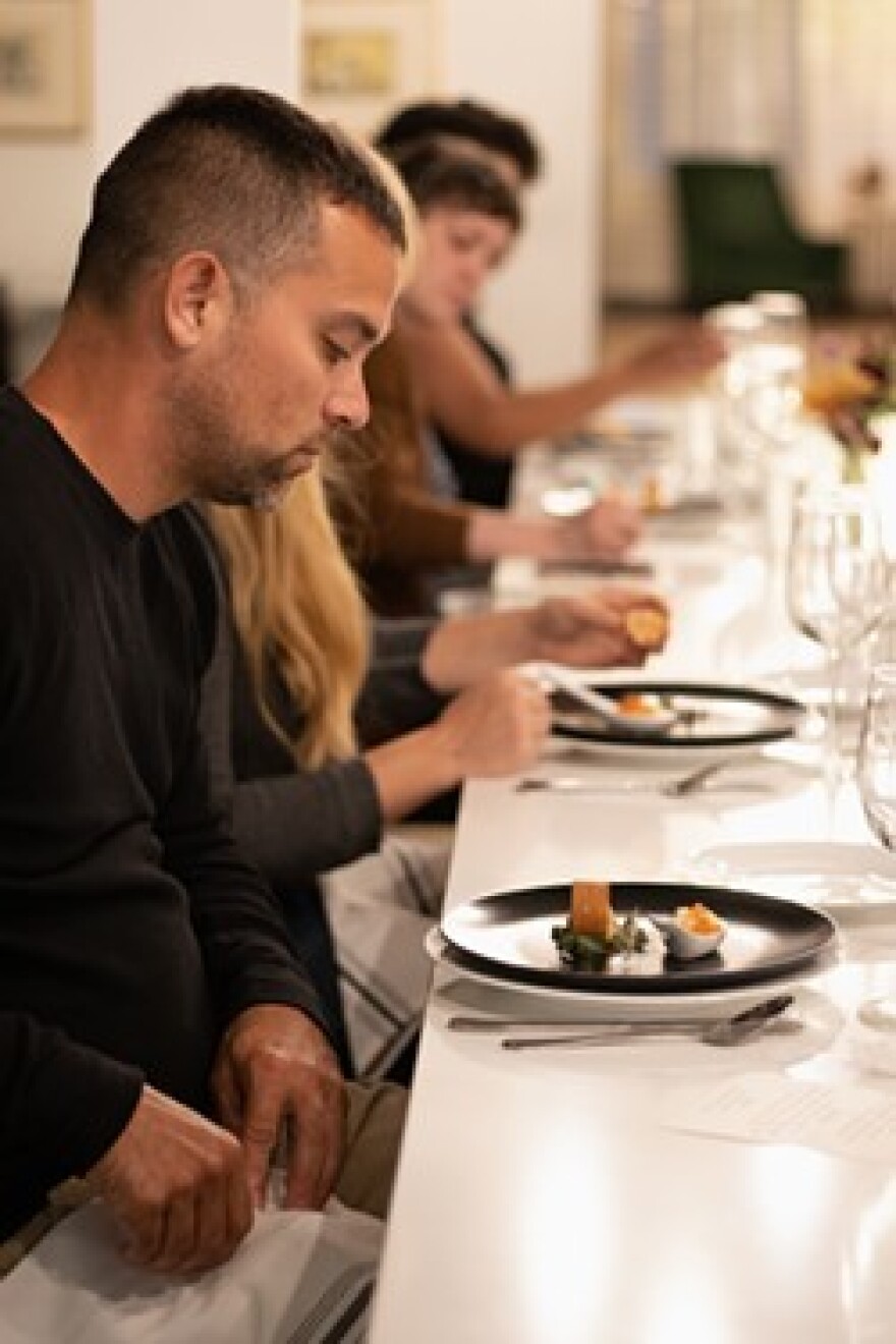 Guests prepare to dig into the appetizer course that featured king salmon and diced apple paired with cauliflower custard and salmon roe.