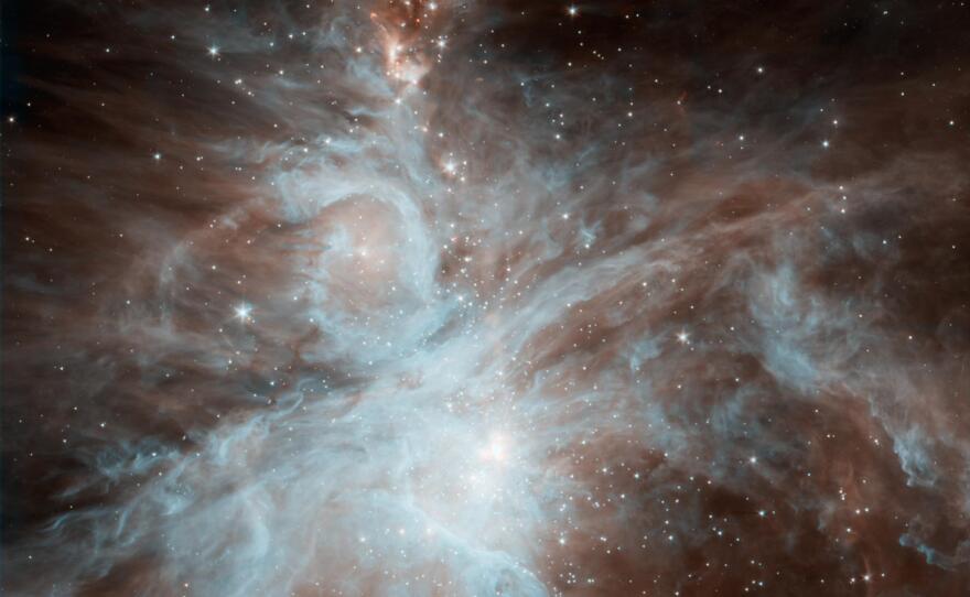 A colony of hot, young stars is stirring up the cosmic scene in this new picture from NASA Spitzer Space Telescope. The image shows the Orion nebula, a happening place where stars are born.