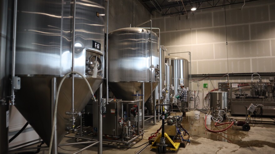 Large chrome tanks and other equipment in a brewing operation