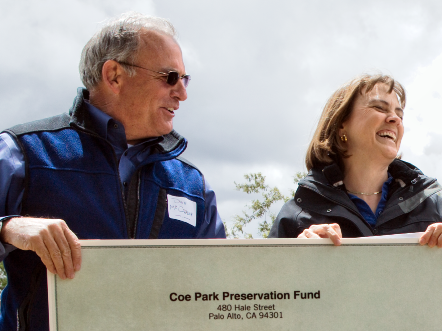 Dan McCranie (left) hands over a check for $279,000 to Ruth Coleman, director of California State Parks, at a ceremony at Coe Park in May. The amount is the first installment of about $900,000 from the Coe Park Preservation Fund that will keep the park open for three years.