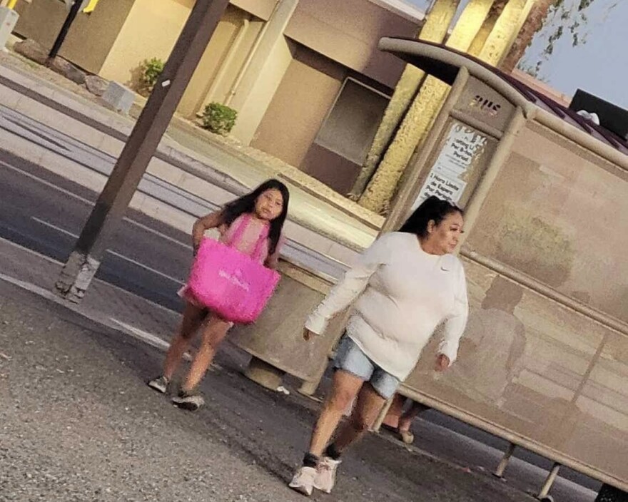  Stewart and another younger volunteer look for Native relatives near a bus stop in Phoenix.