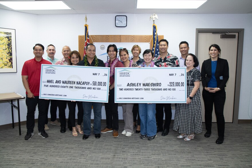 Two new homeowners receive their ceremonial checks for closing on their mortgage through the Hale Kamaʻāina Mortgage Program on May 7, 2026.