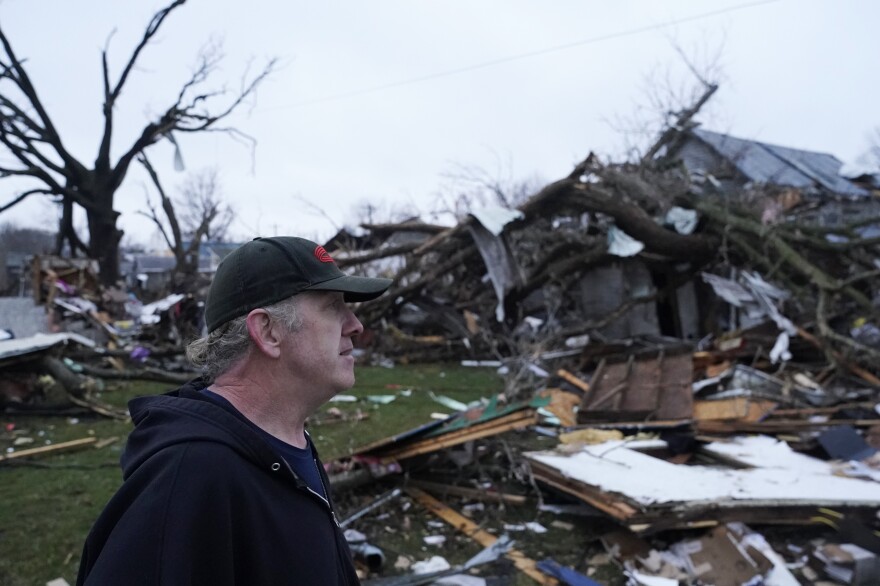 Greg McDougle walks near debris on Friday, following a severe storm in Lakeview, Ohio.