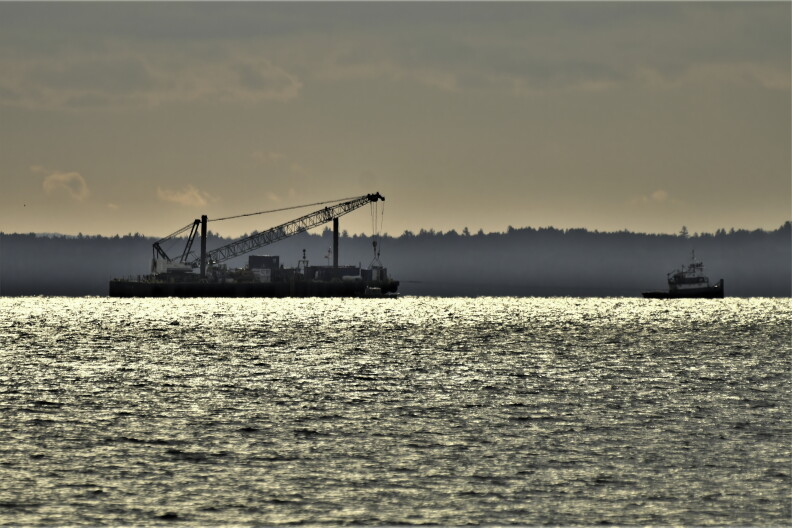 contractors work on line 5 in a body of water