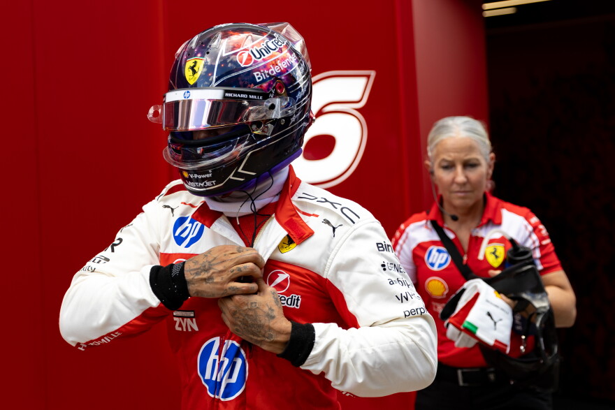 Lewis Hamilton and performance coach Angela Cullen leave the Ferrari garage after the third practice session on Saturday.