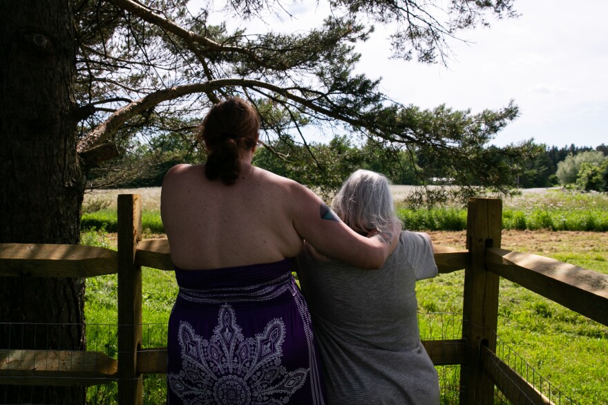 Gilbert and her wife, Alexandra, stand in their yard in upstate New York. Gilbert is suing Dell for, among other things, allegedly discriminating against her for her gender transition. The case is ongoing.