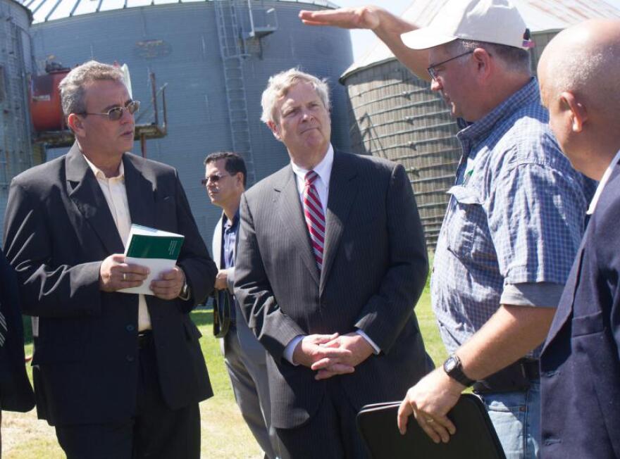 Then U.S. Secretary of Agriculture Tom Vilsack (center) and Cuban Agriculture Minister Gustavo Rodriguez Rollero (left) listen to Central Iowa farmer Aaron Lehman during a tour of Lehman's farm on June 3, 2016.