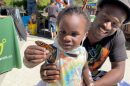 Father and daughter discovering a Monarch butterfly