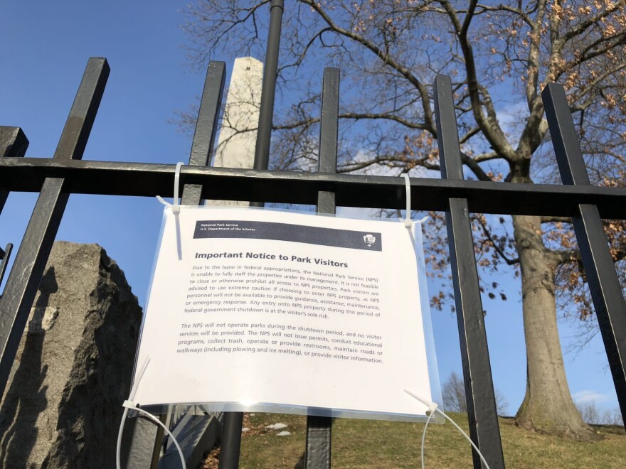 A sign posted at the Bunker Hill Monument in Charlestown, explaining the reason behind the closure. (Simón Rios/WBUR)