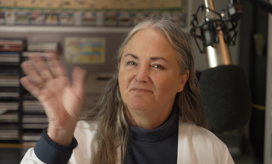 Cordelia Brown waves from a KPR studio during her show, Morning Classical.