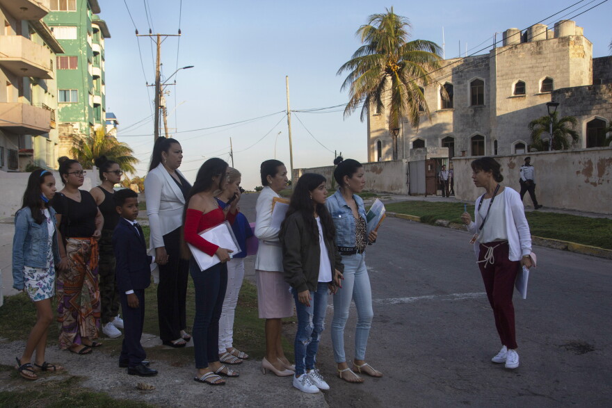 FILE - People wait in a line as they are organized to enter the U.S. embassy on the day of its reopening for visa and consular services in Havana, Cuba, Jan. 4, 2023. (AP Photo/Ismael Francisco, File)