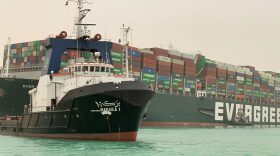 A giant container ship ran aground in the Suez Canal after a gust of wind blew it off course, the vessel's operator said, bringing marine traffic to a halt along one of the world's busiest trade routes. 
