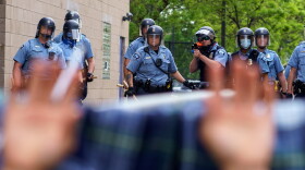 Protesters are trapped between police and other protesters who gathered in a call for justice for George Floyd following his death in Minneapolis, Minnesota. (Kerem Yucel/AFP/Getty Images)