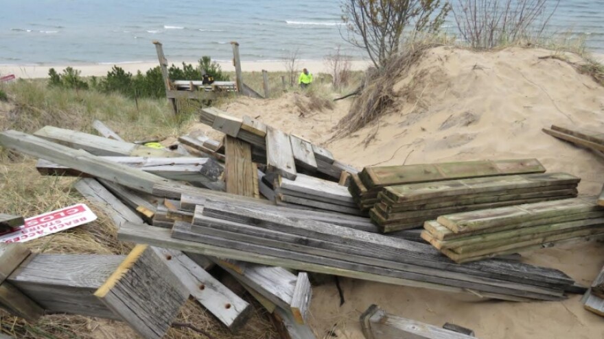 Wood from demolished beach stairs awaits removal May 6, 2025, at Laketown Township Beach