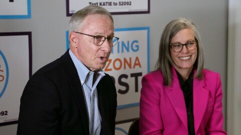 Arizona Democratic Gov. Katie Hobbs, right, smiles as she listens to her running mate for Lieutenant Governor John Giles, the former Republican Mesa, Ariz., mayor, answer a question, Monday, Aug. 10, 2026, in Phoenix. (AP Photo/Ross D. Franklin)