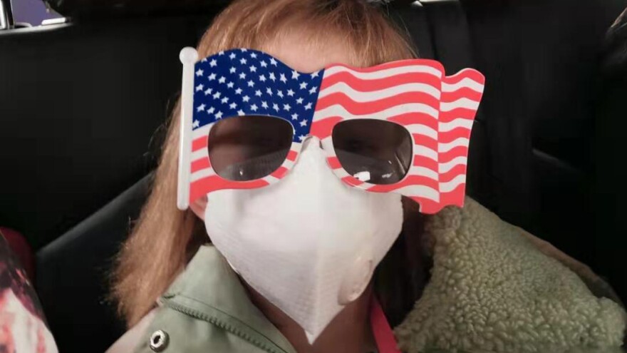 Hermione Dickey, 8, and her mother, Priscilla, head to the Wuhan Tianhe International Airport. They were among the passengers on a U.S. evacuation flight out of Wuhan, China.