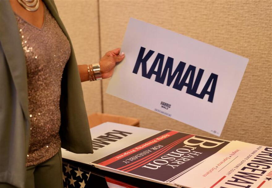 A support holds a Kamala Harris sign at the Monroe County Democrats' gathering at the Hyatt hotel in downtown Rochester on election night