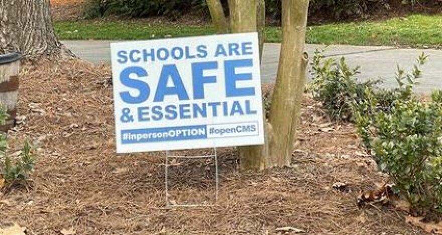 Charlotte-Mecklenburg Schools parents are posting yard signs urging the district to reopen in-person classes.
