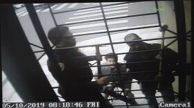 An image from surveillance camera video shows the encounter with police at the home of journalist Bryan Carmody in May. A judge this week quashed a search warrant used by the San Francisco Police Department.