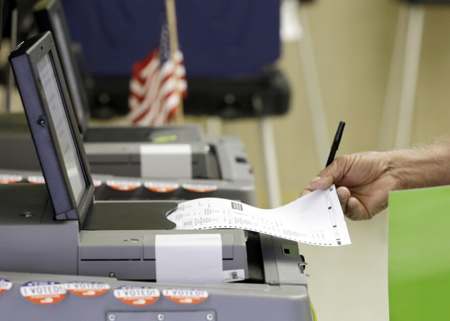A voter casts his primary vote, Tuesday, Aug. 30, 2016, at Precinct 33, in Hialeah, Fla. Florida voters will select the nominees for U.S. Senate, decide whether to amend the state constitution to give a property tax break to promote solar energy and have a say in who should represent them in the U.S. House. (AP Photo/Alan Diaz)
