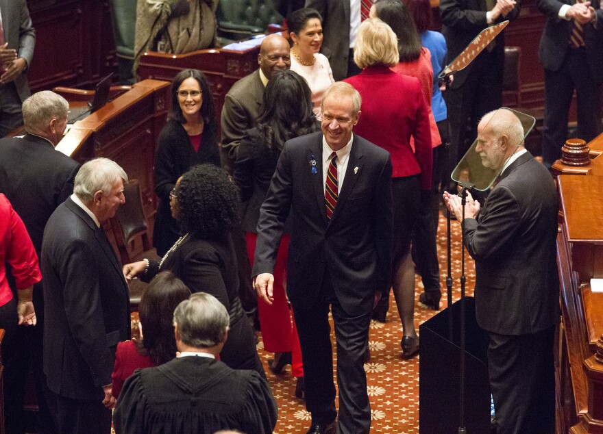 Gov. Bruce Rauner greats lawmakers who gathered for his budget address.