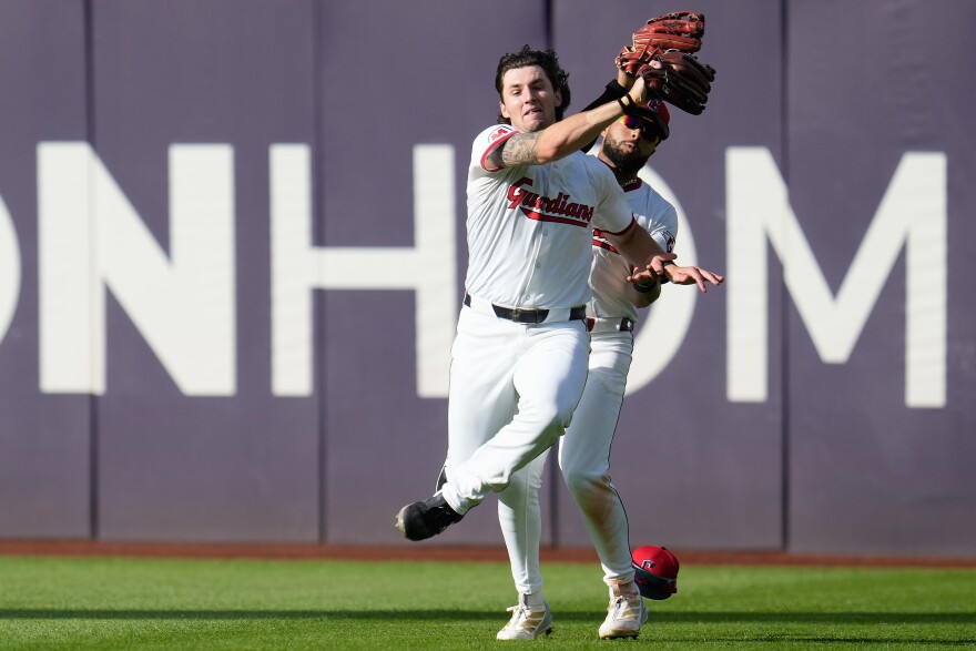 Cleveland Guardians center fielder Chase DeLauter (34) catches a fly ball hit by Detroit Tigers' Riley Greene (31) while avoiding a collision with right fielder George Valera (35) during the sixth inning of Game 3 of the American League Wild Card baseball playoff series in Cleveland, Thursday, Oct. 2, 2025. 