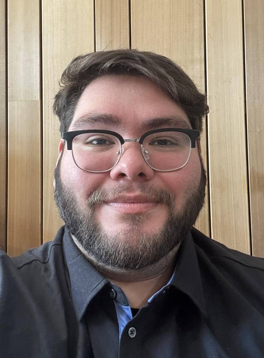 close up of bearded, brown -haird man, wearing glasses