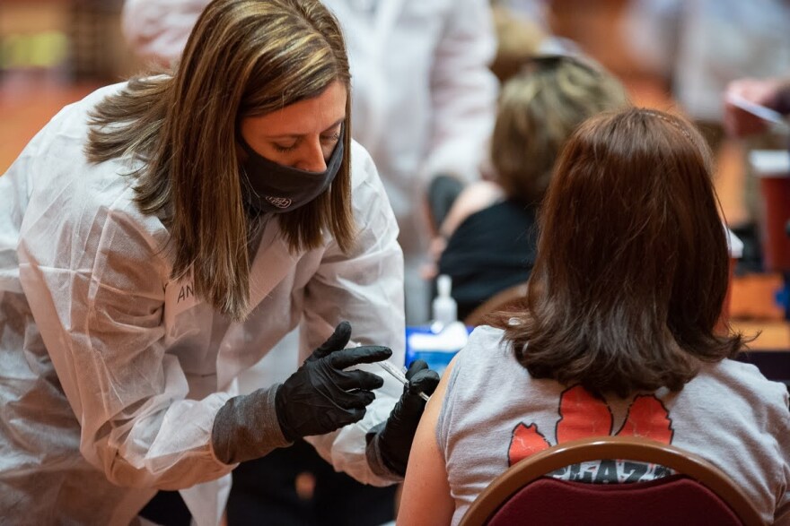 Janene Stewart, director of operations at Norman Regional Hospital, administers a COVID-19 vaccine in Norman last month on the day teachers and adults with comorbidities became eligible to receive the vaccines.