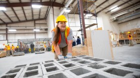 Crystal Lansdale carrying concrete blocks during a practice at a TRAC workshop in the Washington Corrections Center for Women in Gig Harbor, Wash.