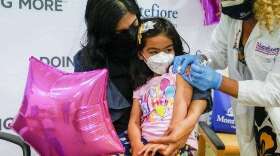 Shivani Agarwal, left, holds her daughter Kiran, 3, as registered nurse Margie Rodriguez administers the first dose of the Moderna COVID-19 vaccine for children 6 months through 4 years old, Tuesday, June 21, 2022, at Montefiore Medical Group in the Bronx borough of New York. (Mary Altaffer /AP)