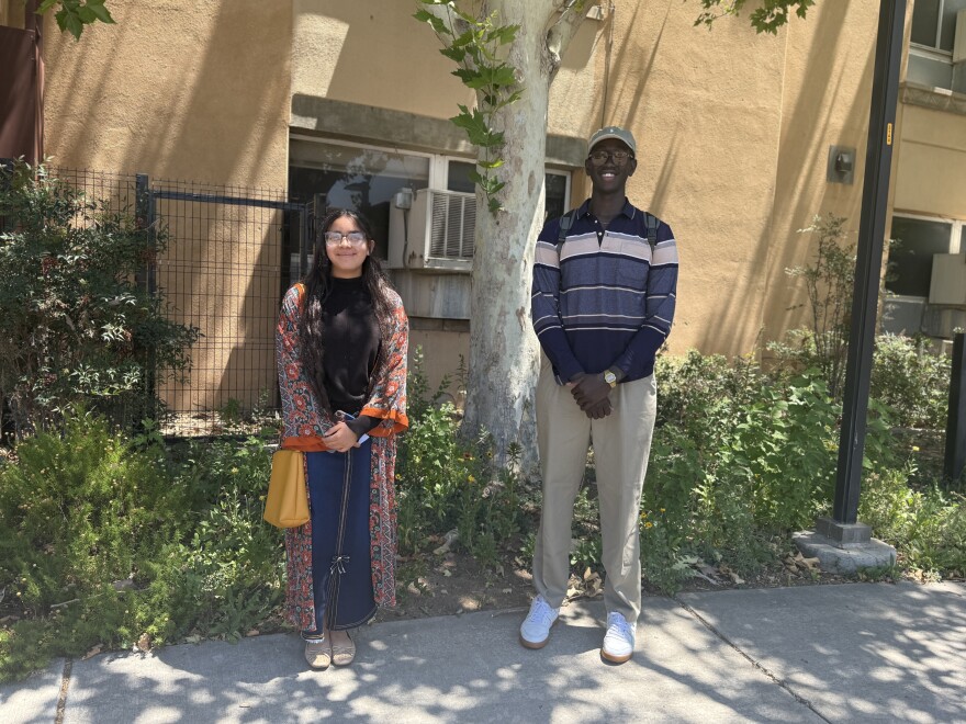 Areli Garcia, on the left, and Daudi Tombe, on the right standing outside of the KUNM studio.