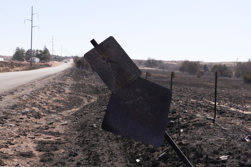 A wildfire charred a road sign in Woodward.