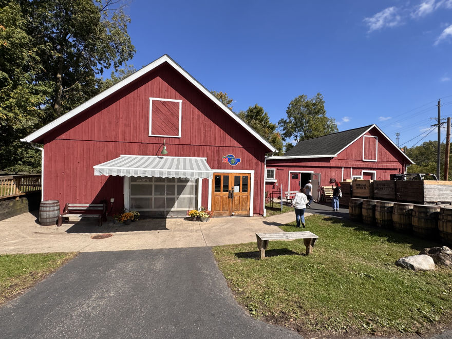 two red barns against a bright blue sky