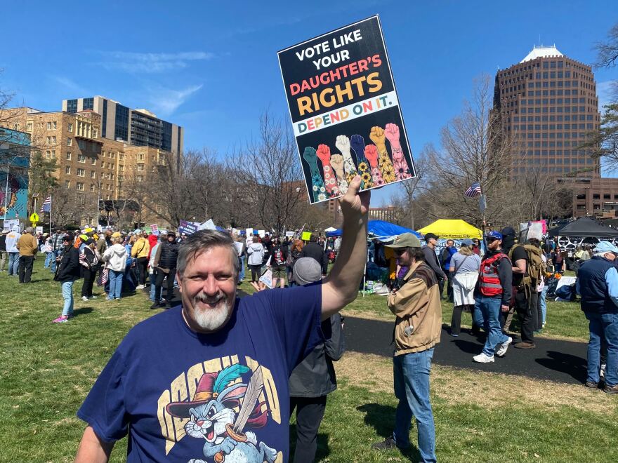 Ryan Reed, of Olathe, Kansas, joins the Kansas City No Kings protest on Saturday. He said he supports women's rights and opposes the SAVE Act.