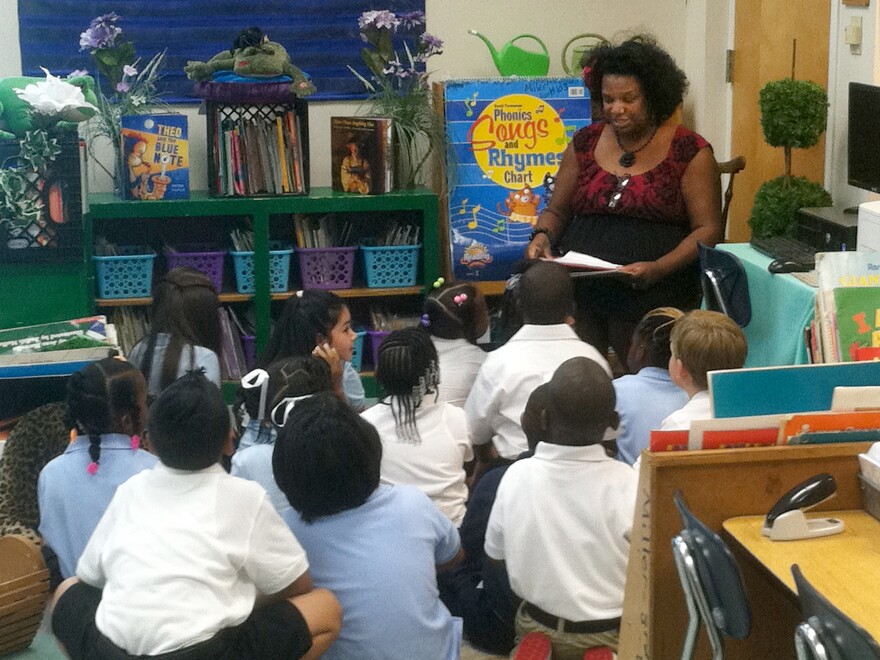 First-grade teacher Euginia Miller reads to her class at Avondale Elementary School in Birmingham, Ala. In this crucible of the civil rights movement, the city's schools are being reintegrated, as a handful of middle-class parents ignore the school district's poor reputation and enroll their kids in the city's public schools.