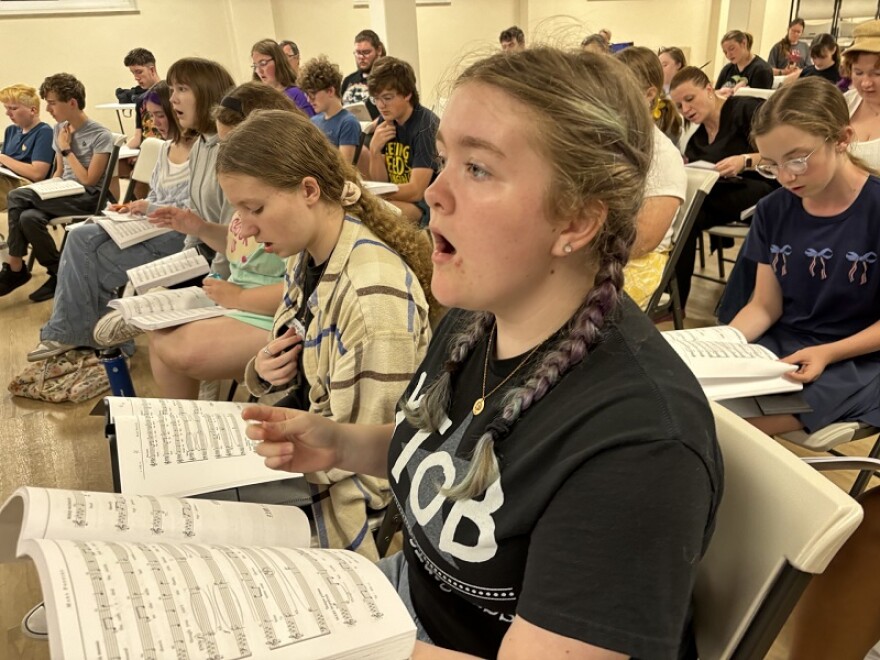 Amelia Hurst wears braids and sings out at rehearsal. She has multiple roles in the production.
