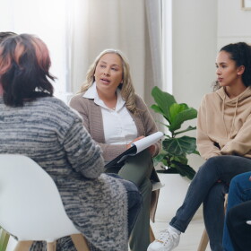 Counseling, group and psychology discussion with group of diversity people in therapy for depression, stress and anxiety. Men and women healing during psychologist meeting talking about mental health.