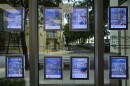 Digital signs advertising homes for sale adorn the window of a London Foster realty office, in Kendall, Fla., Thursday, Oct. 19, 2023. The long-standing real estate commission structure is under legal scrutiny in several courts.