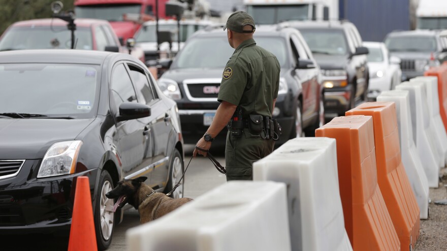 A Border Patrol agent keeps watch at a checkpoint station in Falfurrias, Texas, where a group of high school students were stopped in late June.