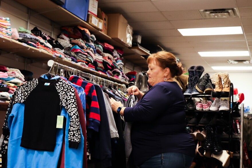 Executive Director Kim Kerschen sorts through clothing donated to Locker 505