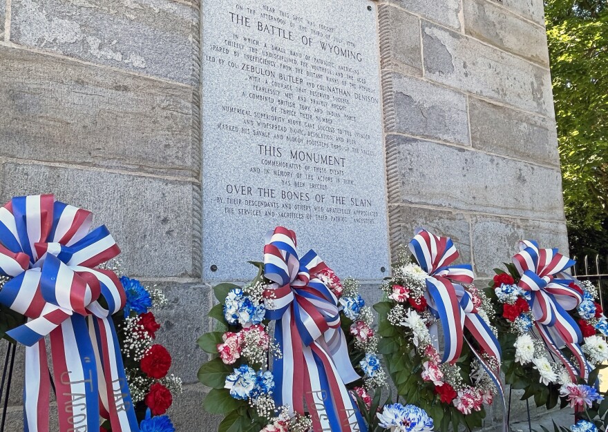 Floral tributes to patriots killed in the 1778 Battle and Massacre of Wyoming stand at the base of the Wyoming Monument in Wyoming Borough during an annual commemoration of the bloody clash during the Revolutionary War.