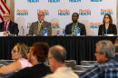 4 people on a panel list to speakers in the audience 