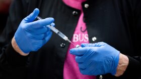 A healthcare worker fills a syringe with the COVID-19 Pfizer vaccine.