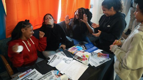 Teens attend the open house for the new northside hub of the Center for Teen Empowerment, listening to music on their phones. The organization is expanding its reach in Rochester with a new location at Dewey and Magee avenues in the historic Maplewood neighborhood.