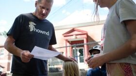 Man with child looks at paper. 