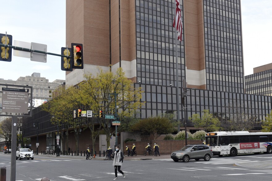 People and traffic move on the streets in front of the James A. Byrne United States Courthouse, Tuesday, Nov. 3, 2020, in Philadelphia.
