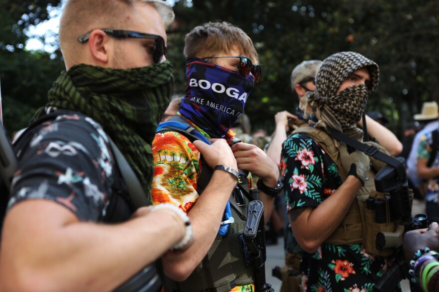 Members of the Boogaloo movement carry semi-automatic firearms during a gun rights rally in Richmond, Va., on Saturday. The Hawaiian shirt-wearing so-called "boogaloo boys" are part of an amorphous movement of disenchanted, mostly white men who think another Civil War is inevitable, even necessary, to correct an overreaching federal government and other societal ills.