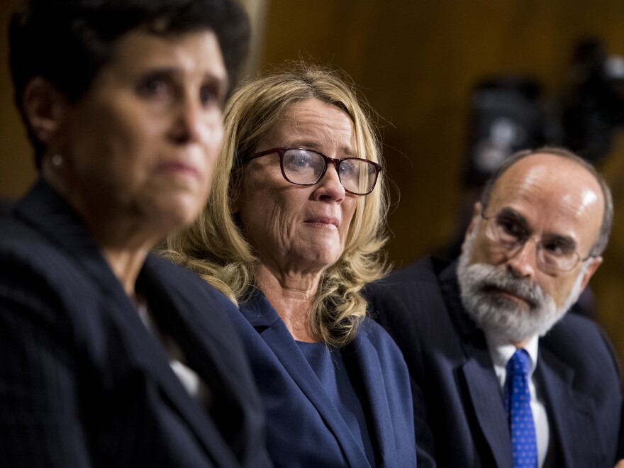 Christine Blasey Ford (center), flanked by attorneys Debra Katz, left, and Michael Bromwich. The attorneys say that although Ford has tried to return to her life, she endures harassment.