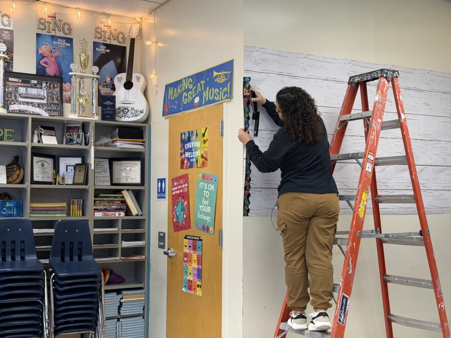 Music teacher Dina Linaro puts the finishing touches on her classroom Thursday, Aug. 6 ahead of the new school year.