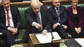 Britain's Prime Minister Boris Johnson speaks to lawmakers inside the House of Commons to update details of his new Brexit deal with EU, in London Saturday Oct. 19, 2019. (Jessica Taylor/House of Commons via AP)